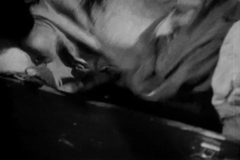 Man hiding item under sheet in tool box, 1940s 스톡 동영상 90727929
