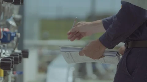 A man in high visibility work gear inspects equipment Video stock 86263038