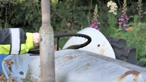 Man with high visibilty jacket turns steering wheel Stock Footage 116132552