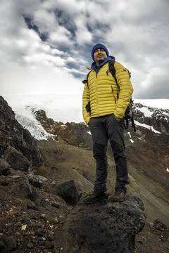 Man hiker with backpack in front of a mountain Stock Photos