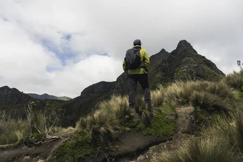 Man hiker with backpack in front of a mountain Stock Photos