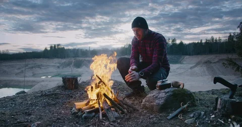 Man hiker make fire in forest.Make the fire in nature. Camping Stock Footage 128526830