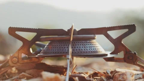 Man hiker Setting Up a Portable gas Camping Stove in the Beautiful Outdoors of Stock Footage 285433662