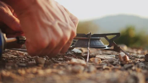 Man hiker Setting Up a Portable gas Camping Stove in the Beautiful Outdoors of Stock Footage 288116375