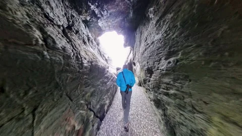 Man Hikes Through Sea Stack and Climbs Rocks Stock Footage 337315613