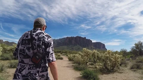 Man Hikes Toward Superstition Mountains In Arizona Desert 4K Stock Footage 313160551