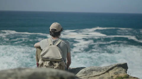 Man hiking close to big cliffs and heavy ocean in Basque Coast, Spain Video stock 154767004