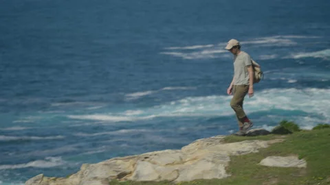 Man hiking close to big cliffs and heavy ocean in Basque Coast, Spain Video stock 154767745