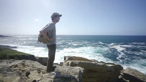 Man hiking close to big cliffs and heavy ocean in Basque Coast, Spain Video stock 154767850