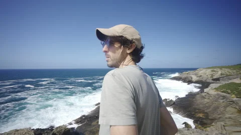 Man hiking close to big cliffs and heavy ocean in Basque Coast, Spain Video stock 154767946