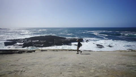 Man hiking close to big cliffs and heavy ocean in Basque Coast, Spain Video stock 154768635