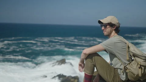 Man hiking close to big cliffs and heavy ocean in Basque Coast, Spain Video stock 154769611