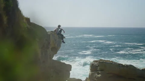 Man hiking close to big cliffs and heavy ocean in Basque Coast, Spain Video stock 154769670