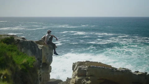 Man hiking close to big cliffs and heavy ocean in Basque Coast, Spain Video stock 154769785