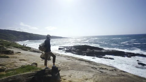 Man hiking close to big cliffs and heavy ocean in Basque Coast, Spain Video stock 154770977