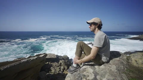 Man hiking close to big cliffs and heavy ocean in Basque Coast, Spain Video stock 154771066