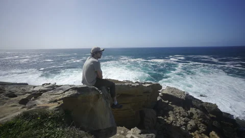 Man hiking close to big cliffs and heavy ocean in Basque Coast, Spain Video stock 154771300