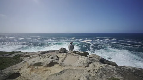 Man hiking close to big cliffs and heavy ocean in Basque Coast, Spain Video stock 154771304