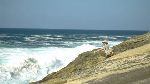 Man hiking close to big cliffs and heavy ocean in Basque Coast, Spain Video stock 154771581