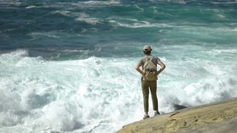Man hiking close to big cliffs and heavy ocean in Basque Coast, Spain Video stock 154771617