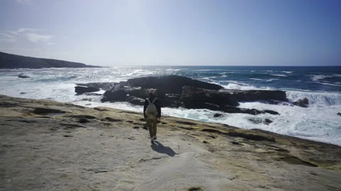 Man hiking close to big cliffs and heavy ocean in Basque Coast, Spain Video stock 154771794