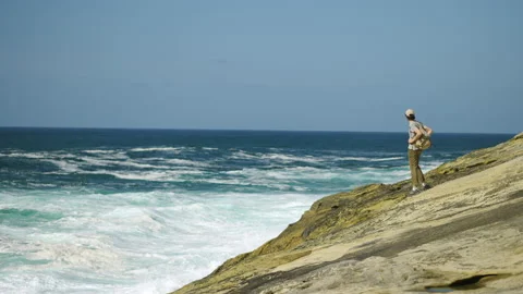Man hiking close to big cliffs and heavy ocean in Basque Coast, Spain Video stock 154771928