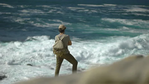 Man hiking close to big cliffs and heavy ocean in Basque Coast, Spain Video stock 154771959