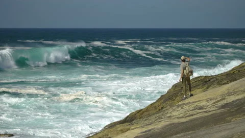 Man hiking close to big cliffs and heavy ocean in Basque Coast, Spain Video stock 154772034