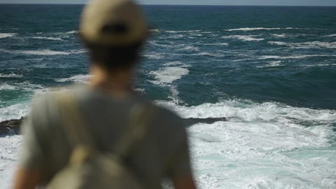 Man hiking close to big cliffs and heavy ocean in Basque Coast, Spain Video stock 154772053