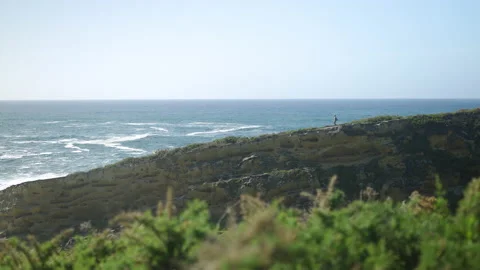 Man hiking close to big cliffs and heavy ocean in Basque Coast, Spain Video stock 154773328