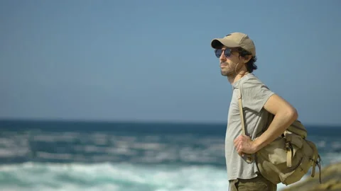 Man hiking close to big cliffs and heavy ocean in Basque Coast, Spain Video stock 154773359