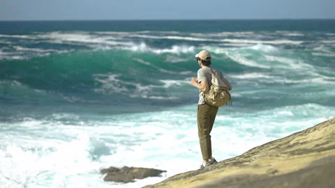 Man hiking close to big cliffs and heavy ocean in Basque Coast, Spain Video stock 154773708