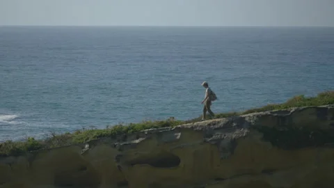 Man hiking close to big cliffs and heavy ocean in Basque Coast, Spain Video stock 154773719