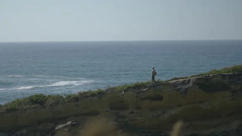 Man hiking close to big cliffs and heavy ocean in Basque Coast, Spain Video stock 154774071
