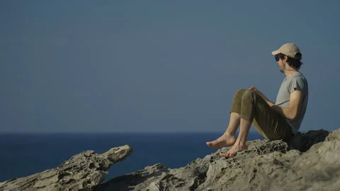 Man hiking close to big cliffs and heavy ocean in Basque Coast, Spain Video stock 154774895