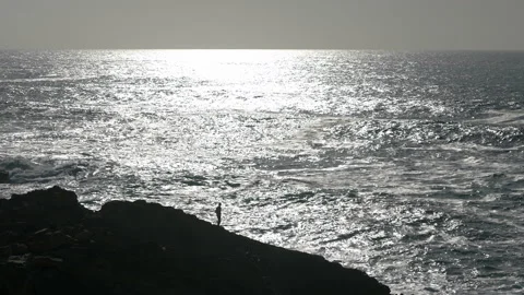 Man hiking close to big cliffs and heavy ocean in Basque Coast, Spain Video stock 154775122