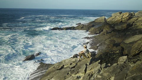 Man hiking close to big cliffs and heavy ocean in Basque Coast, Spain Video stock 154776592