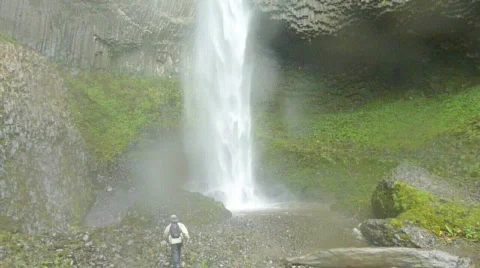 Man Hiking Close to Waterfall Stock Footage 874818