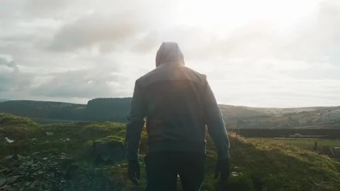 Man hiking on the edge of the small mountain after training. Stock Footage 96875474