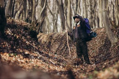 Man hiking in forest Stock Photos