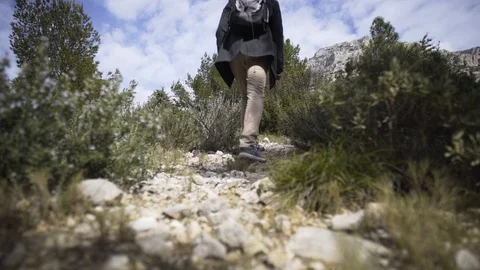 Man hiking with his backpack on a limestone footpath at Calanque de Sugiton Stock Footage 106246608
