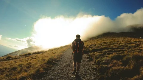 Man hiking in the mountain with backpack, boots and trekking poles. Abruzzo Video stock 100275419