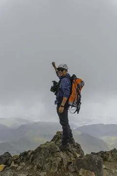Man hiking at mountains with backpack Stock Photos