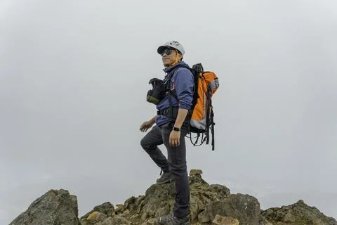 Man hiking at mountains with backpack Stock Photos