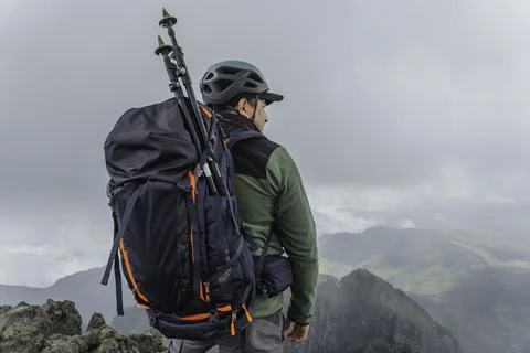 Man hiking at mountains with backpack Stock Photos