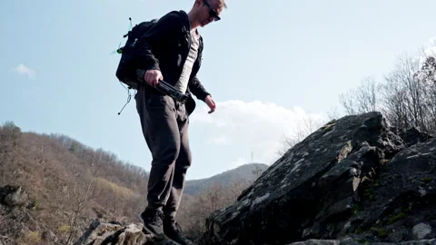 Man Hiking on a Rocky Path with Backpack, Embracing Adventure Outdoors Видео 334339271