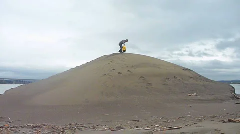 Man Hiking Up Sandy Hill Video stock 2596612