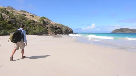 Man hiking on sandy virgin beach on Isla Culebra in the Caribbean Sea Stock Footage 49683665