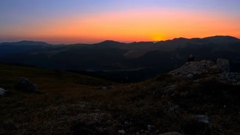 Man hiking at sunset in mountains Stock Footage 79435247