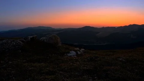 Man hiking at sunset in mountains Stock Footage 79435260
